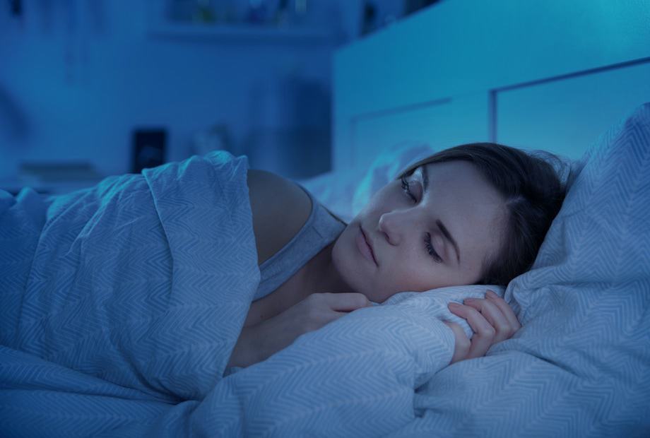 a lady sleeping in blue LED light